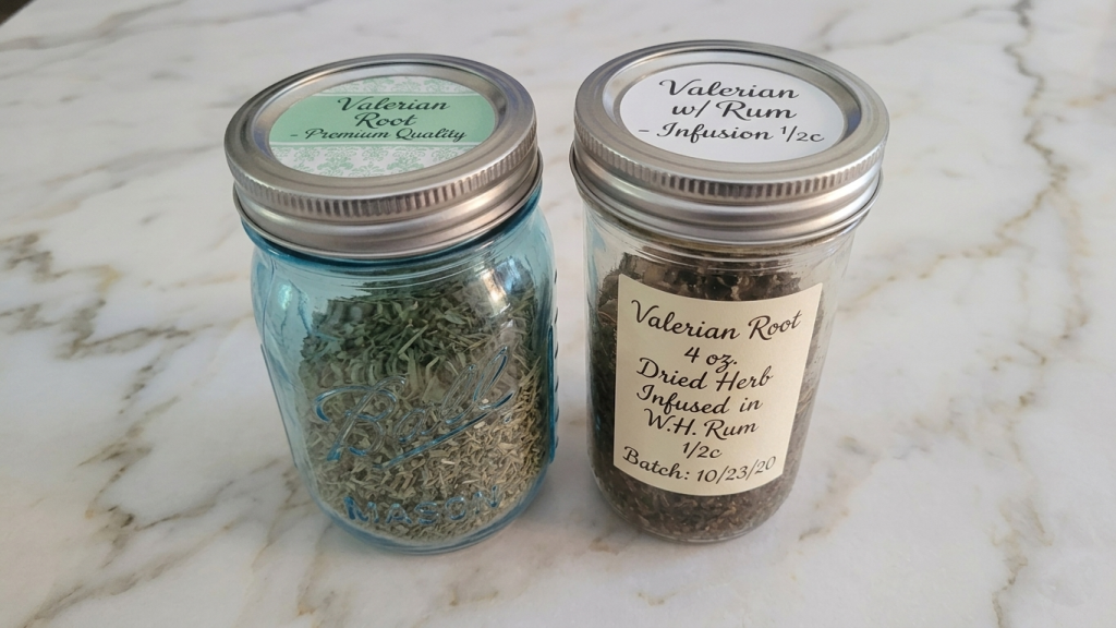 Dried valerian root stored in a glass jar beside a homemade herbal tincture